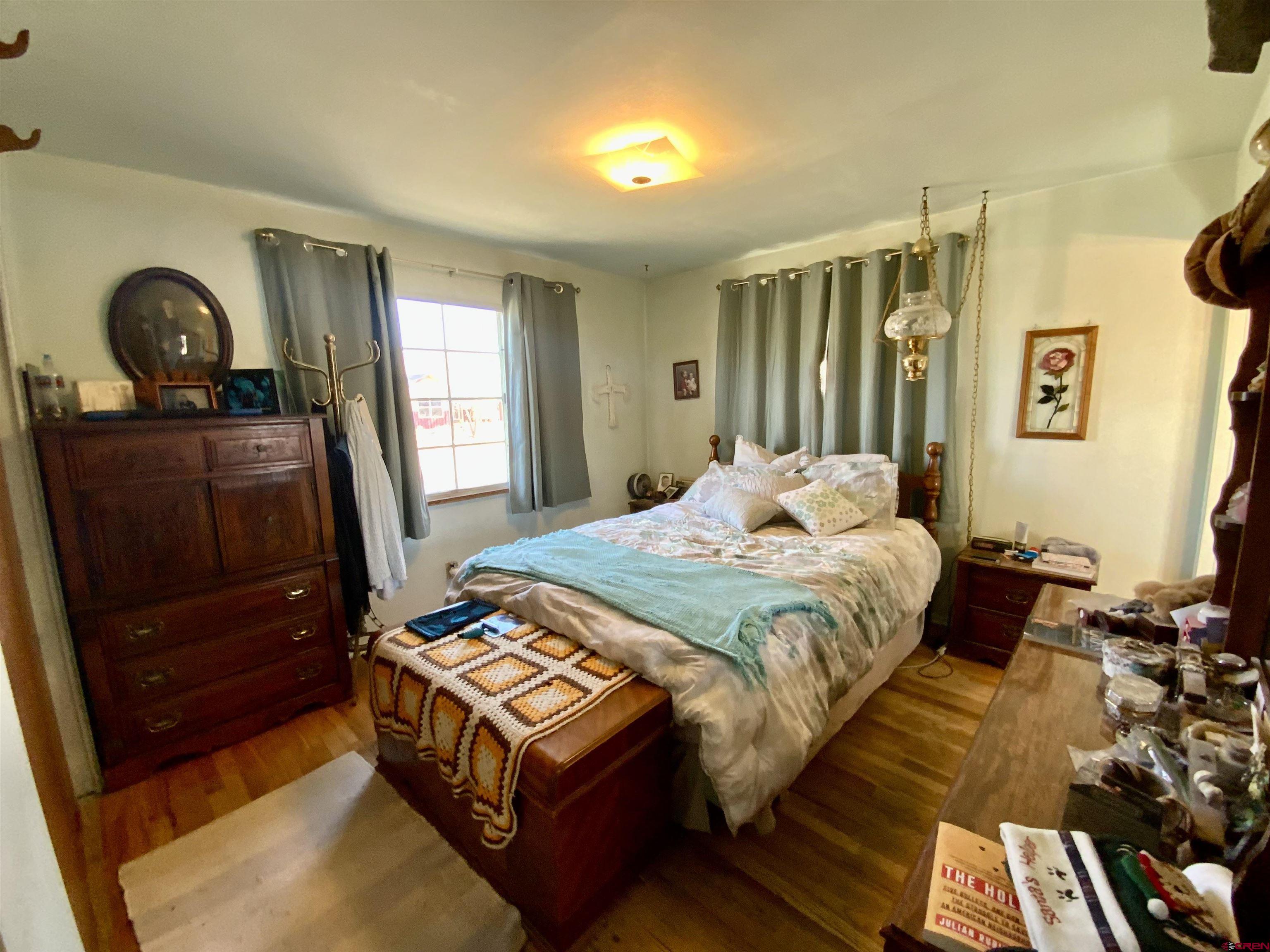 21 Vulcan Street Gunnison, CO 81230 - Photo 7 of 21 a bedroom with a bed next to a window