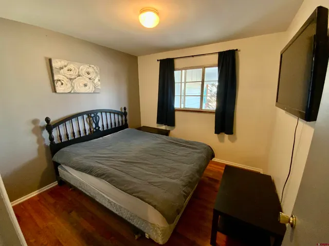 a bed sitting in a bedroom next to a window