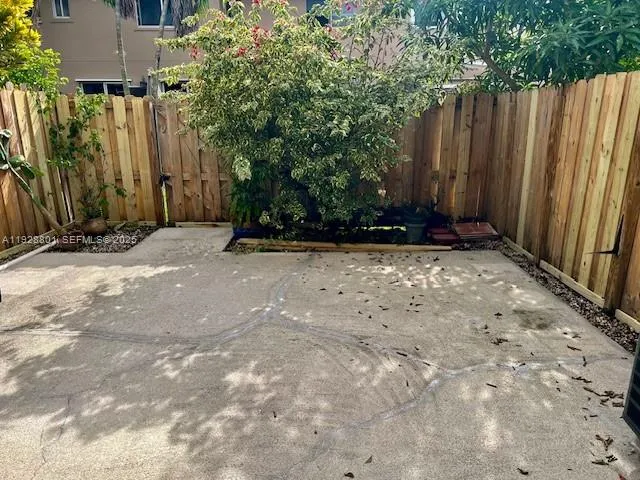 a view of wooden fence under a large tree