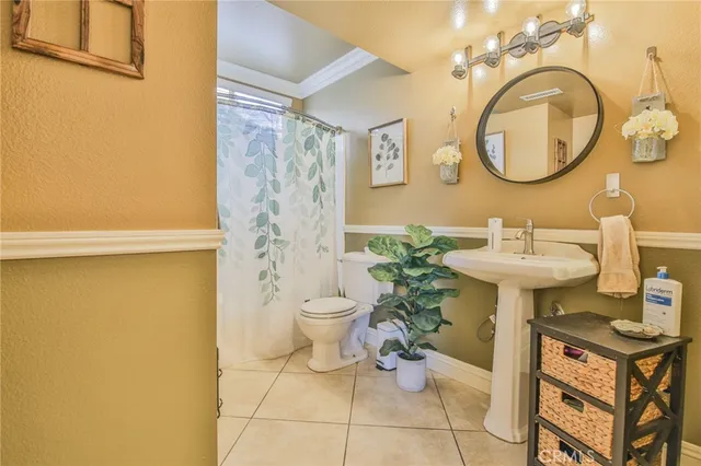 a bathroom with a sink toilet and a mirror