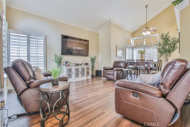 a living room with furniture fireplace and a large window