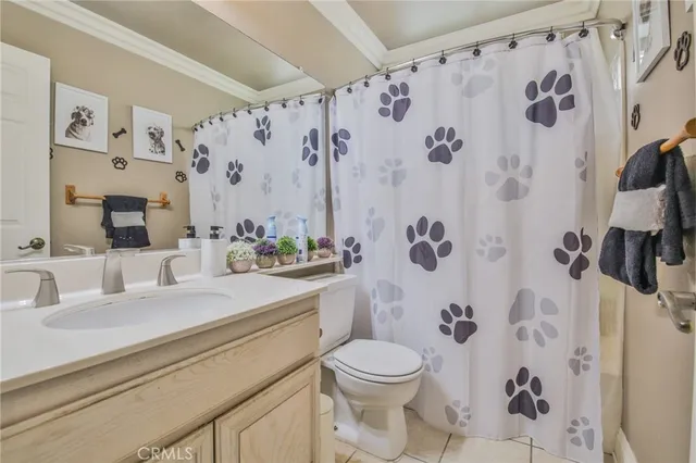 a bathroom with a sink a toilet and a shower curtain