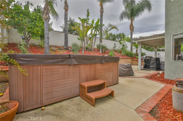 a view of a house with a patio and a yard