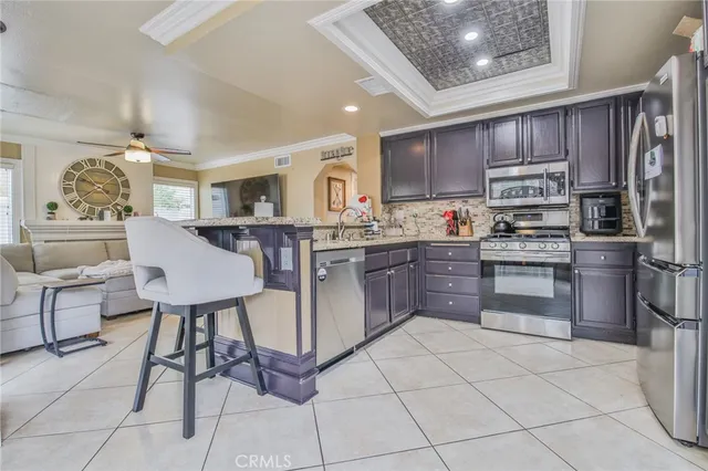 a kitchen with stainless steel appliances granite countertop a stove top oven a sink dishwasher and cabinets
