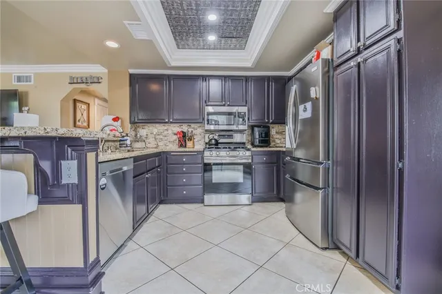 a kitchen with stainless steel appliances granite countertop a refrigerator sink and cabinets
