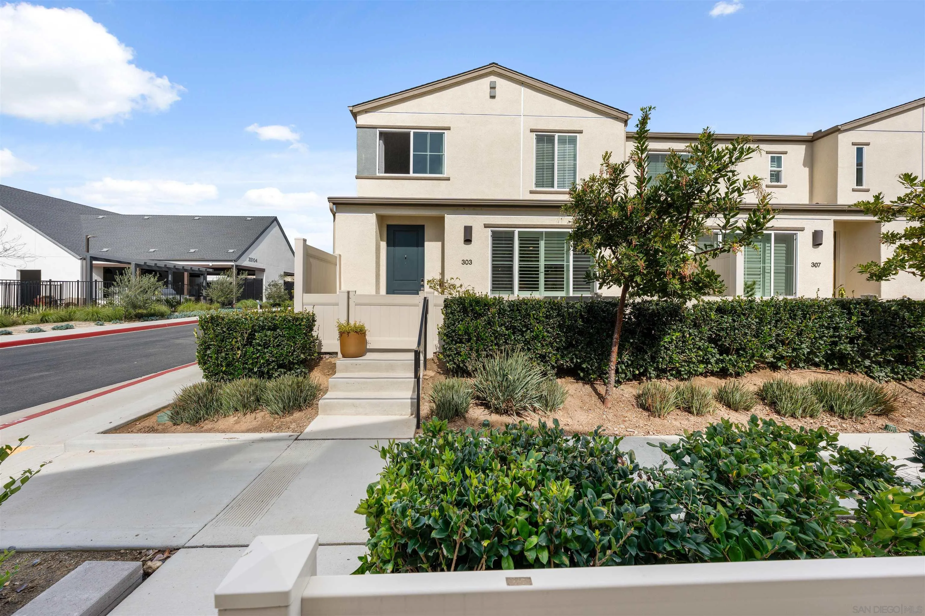 303 Citrine Trail Fallbrook, CA 92028 - Photo 2 of 47 a view of a white house next to a yard
