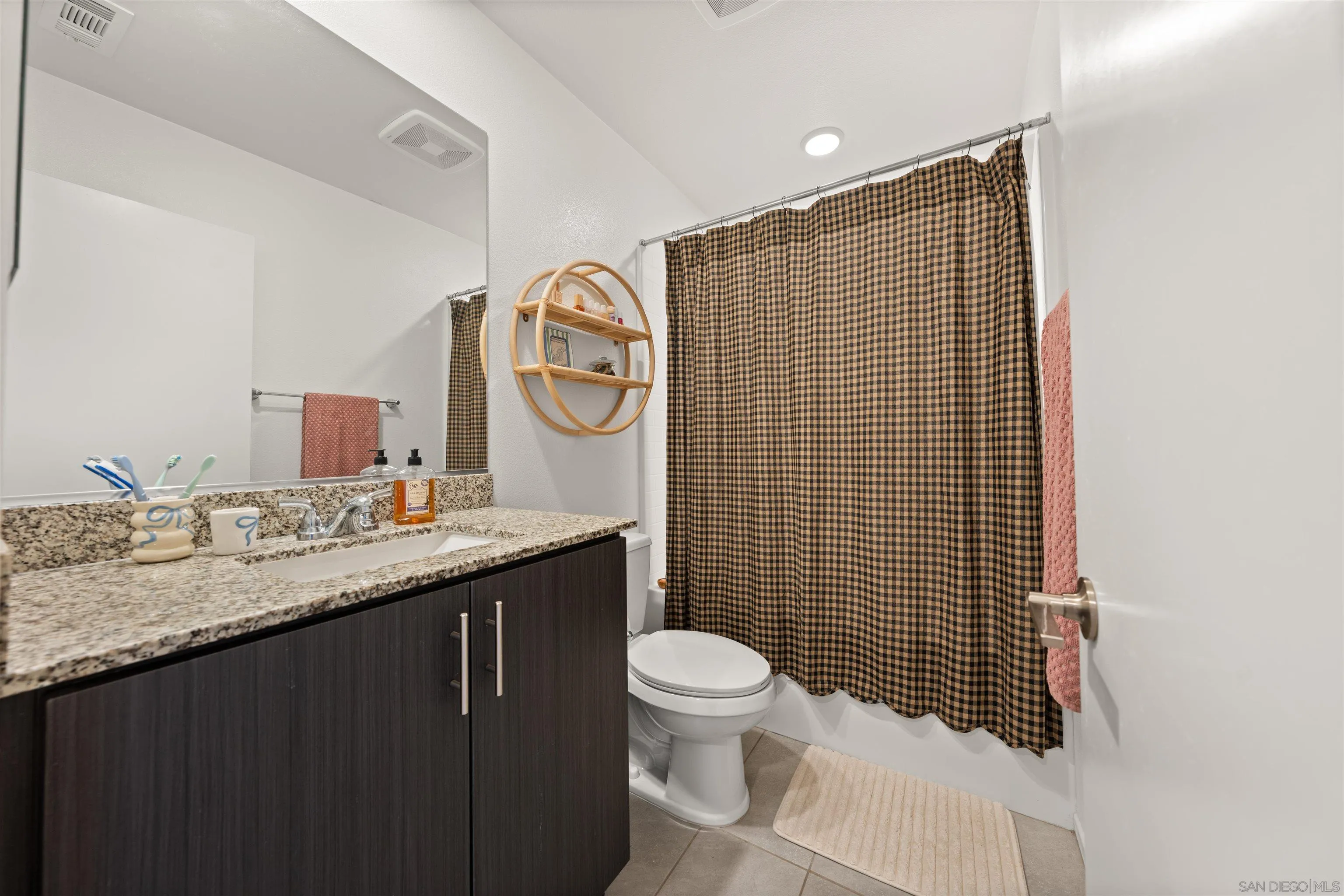 303 Citrine Trail Fallbrook, CA 92028 - Photo 22 of 47 a bathroom with a granite countertop toilet sink and mirror
