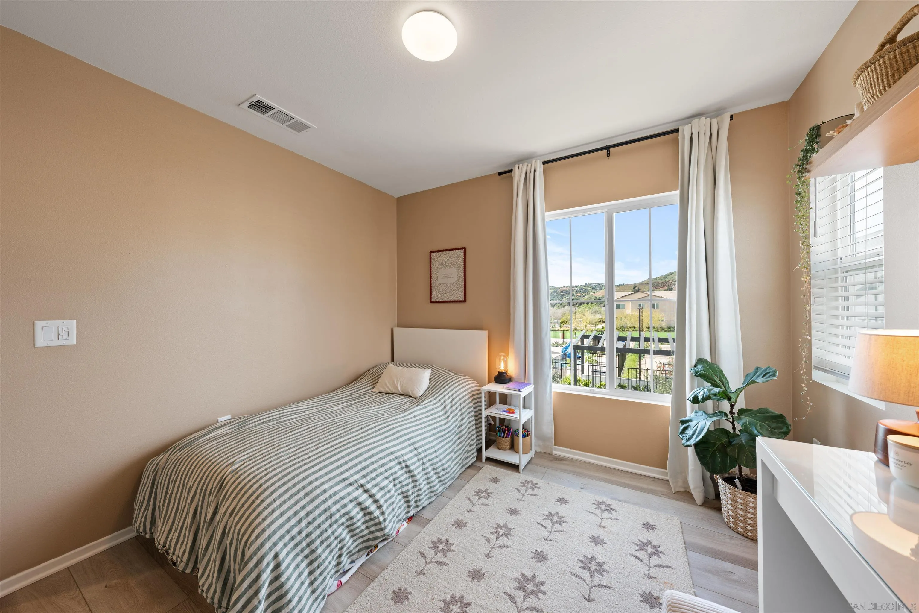 303 Citrine Trail Fallbrook, CA 92028 - Photo 24 of 47 a bedroom with a bed and a couch