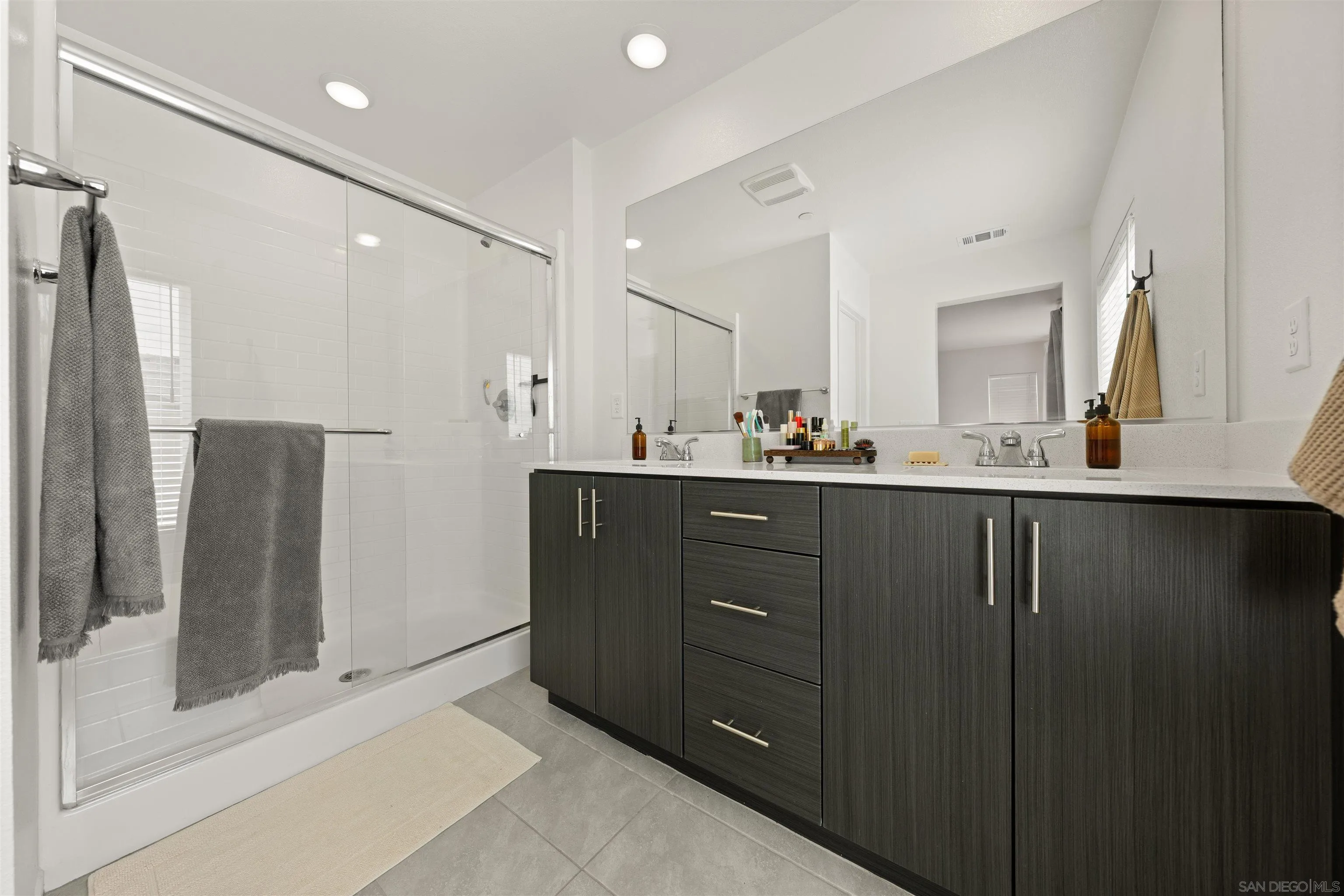 303 Citrine Trail Fallbrook, CA 92028 - Photo 32 of 47 a bathroom with a double vanity sink and mirror