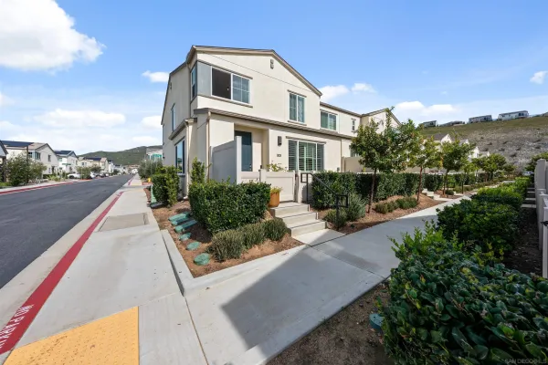 a view of a porch with chairs and potted plants