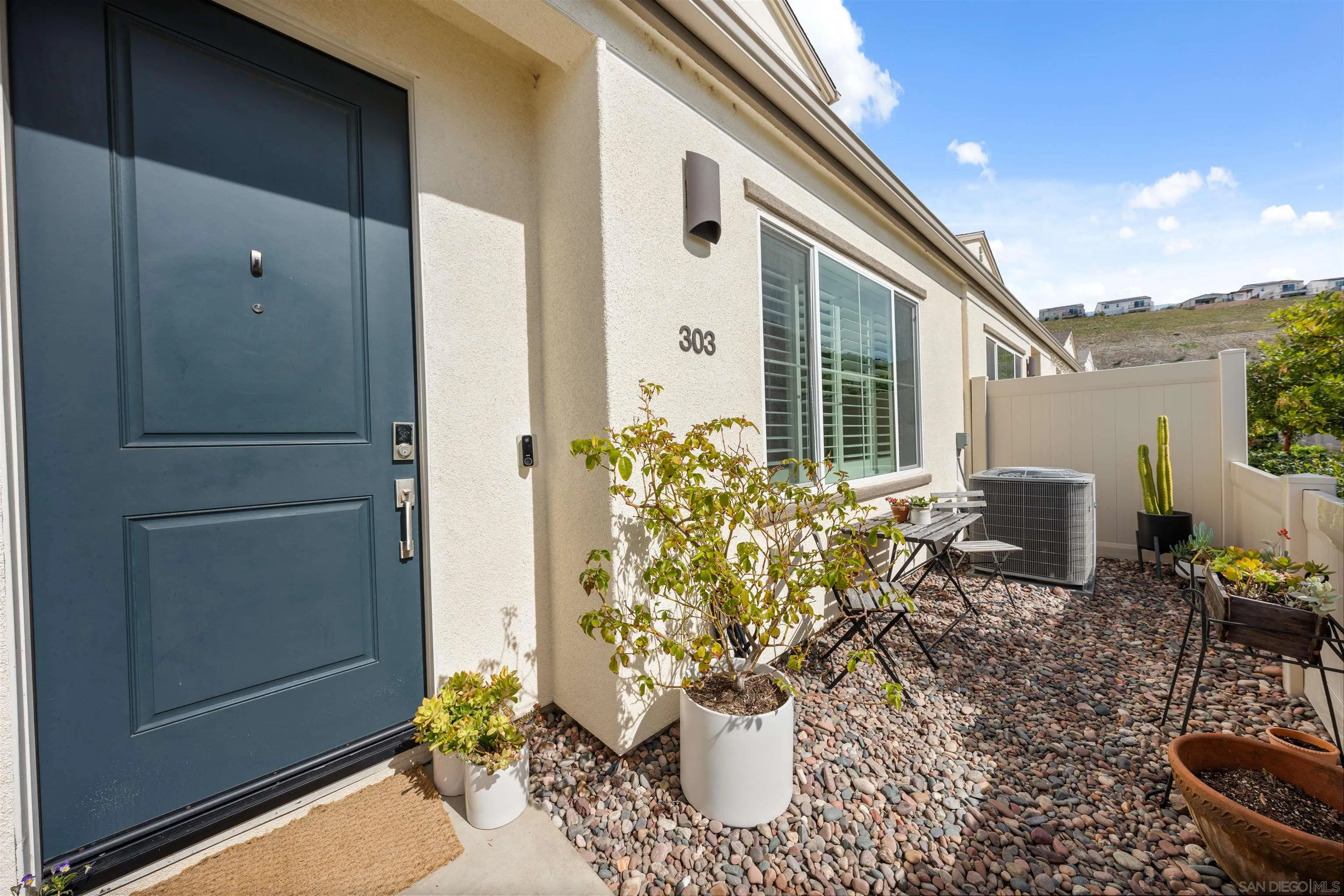 303 Citrine Trail Fallbrook, CA 92028 - Photo 6 of 47 a view of a porch with chairs and potted plants