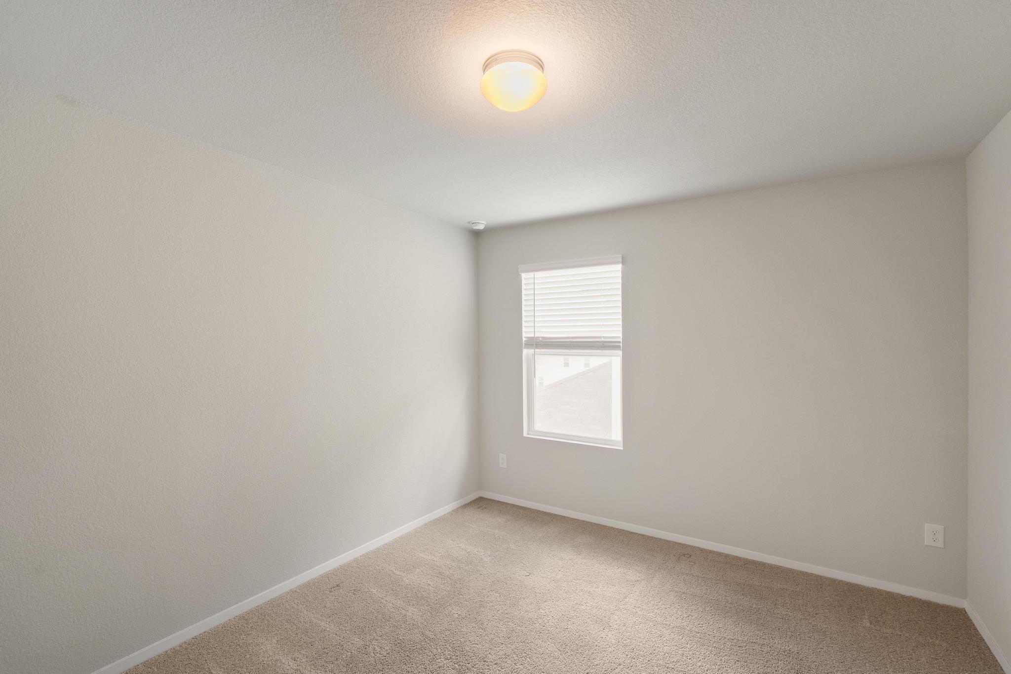 2812 Steels Road Manor, TX 78653 - Photo 21 of 25 Soft carpet and a classic window define this comfortable, versatile space.