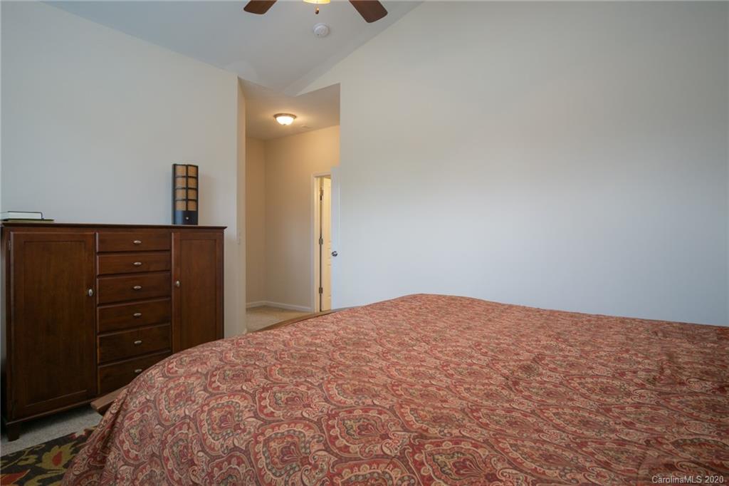 3143 Tanzanite Circle Fort Mill, SC 29708 - Photo 15 of 33 a bedroom with a bed and a lamp on dresser