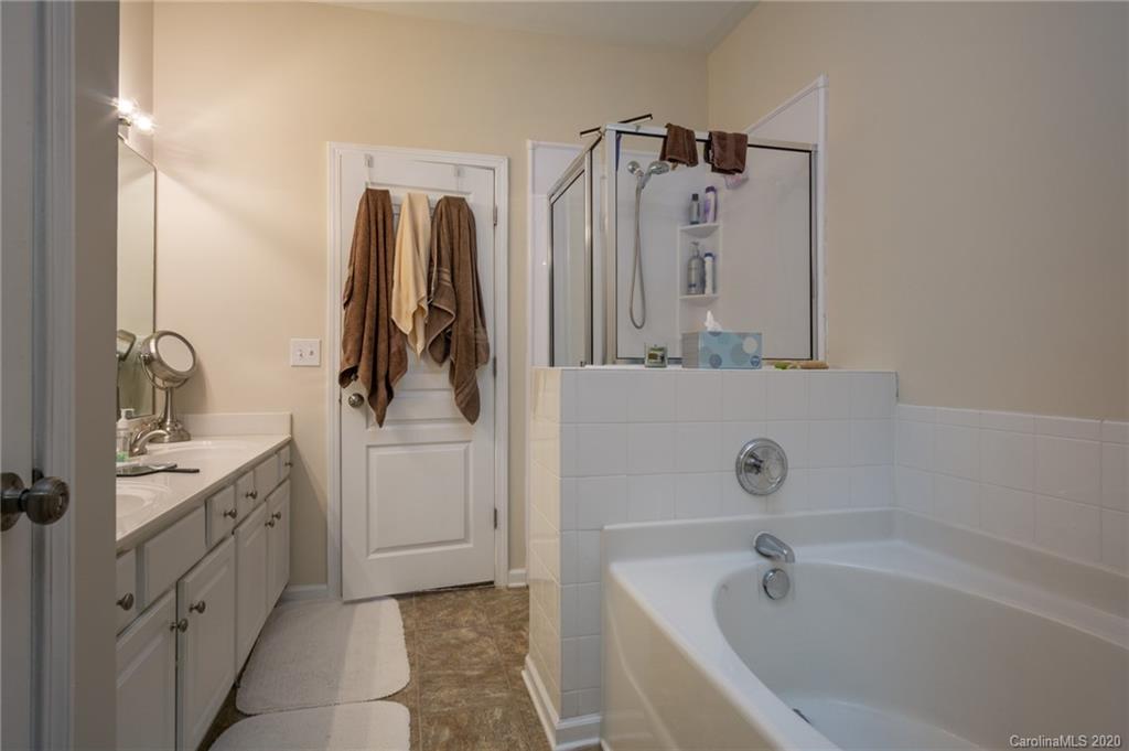 3143 Tanzanite Circle Fort Mill, SC 29708 - Photo 17 of 33 a bathroom with a tub sink and mirror