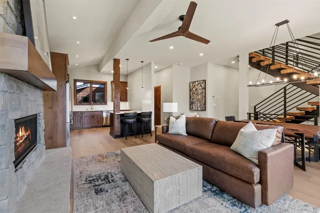 a living room with furniture kitchen view and a fireplace