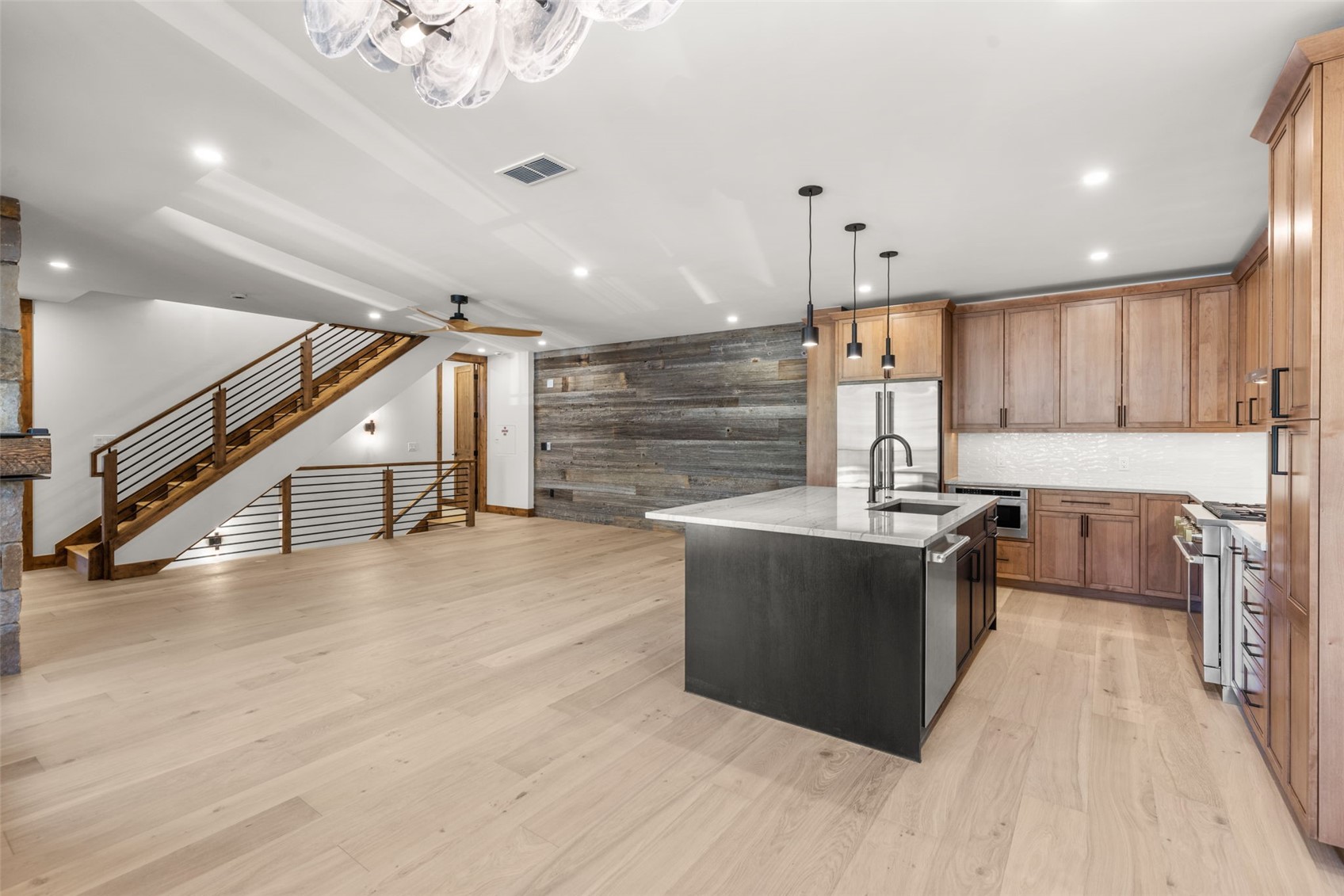 308 3rd Avenue Frisco, CO 80443 - Photo 13 of 45 a large kitchen with stainless steel appliances kitchen island granite countertop a large counter top and stove top oven with wooden floor