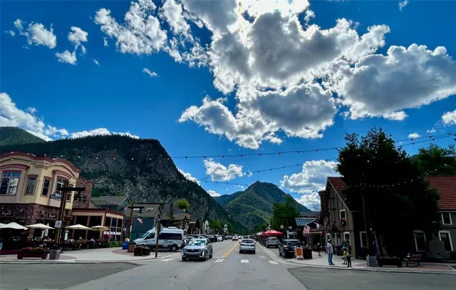 a city street lined with lots of parked cars