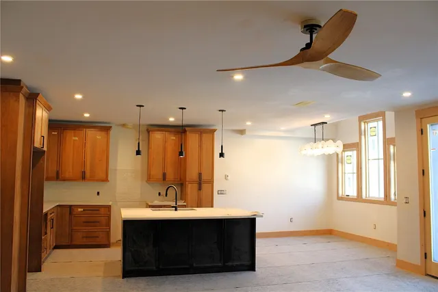 a view of spacious bathroom with a sink a large mirror and shower