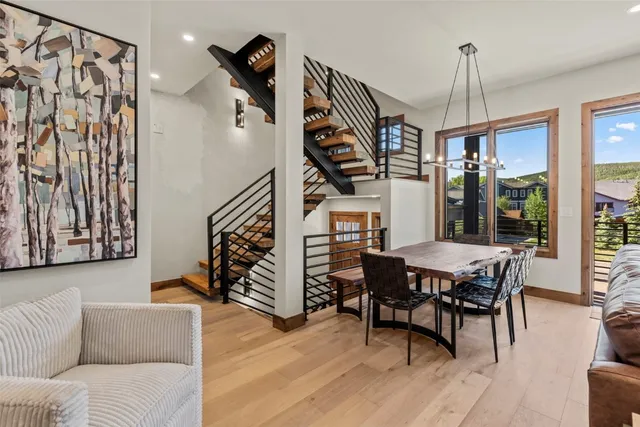 a dining room with furniture entryway and wooden floor