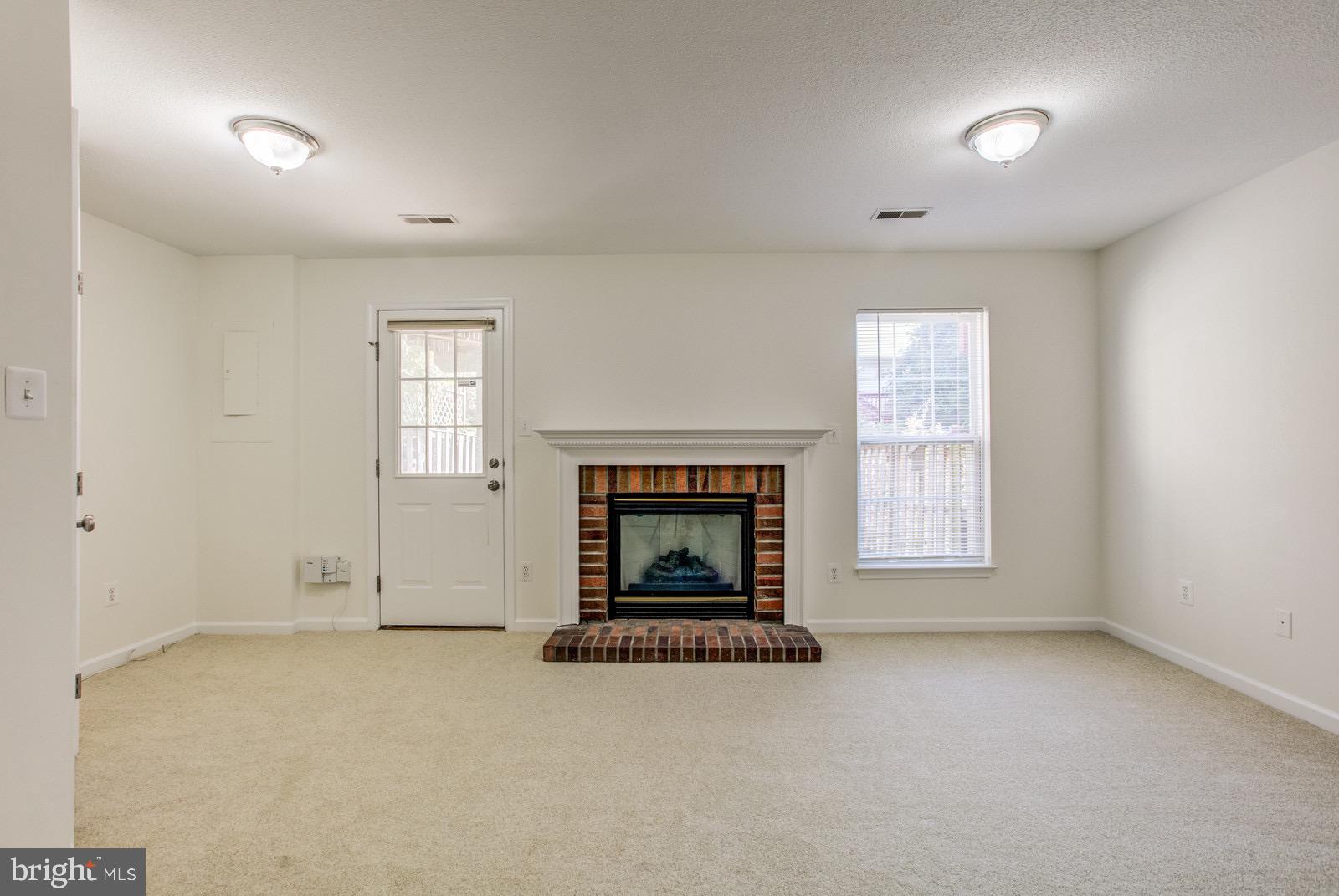 6386 Stagg Court Springfield, VA 22150 - Photo 22 of 30 Lovely fireplace and full length windows.