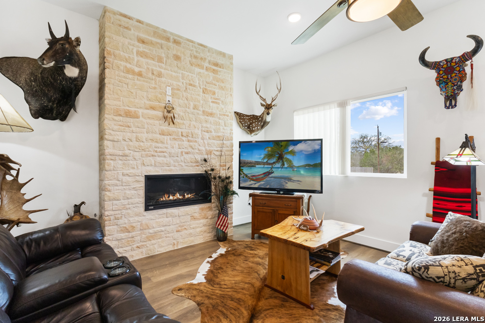 175 Pine Tree Road Medina, TX 78055 - Photo 12 of 34 a living room with furniture and a flat screen tv