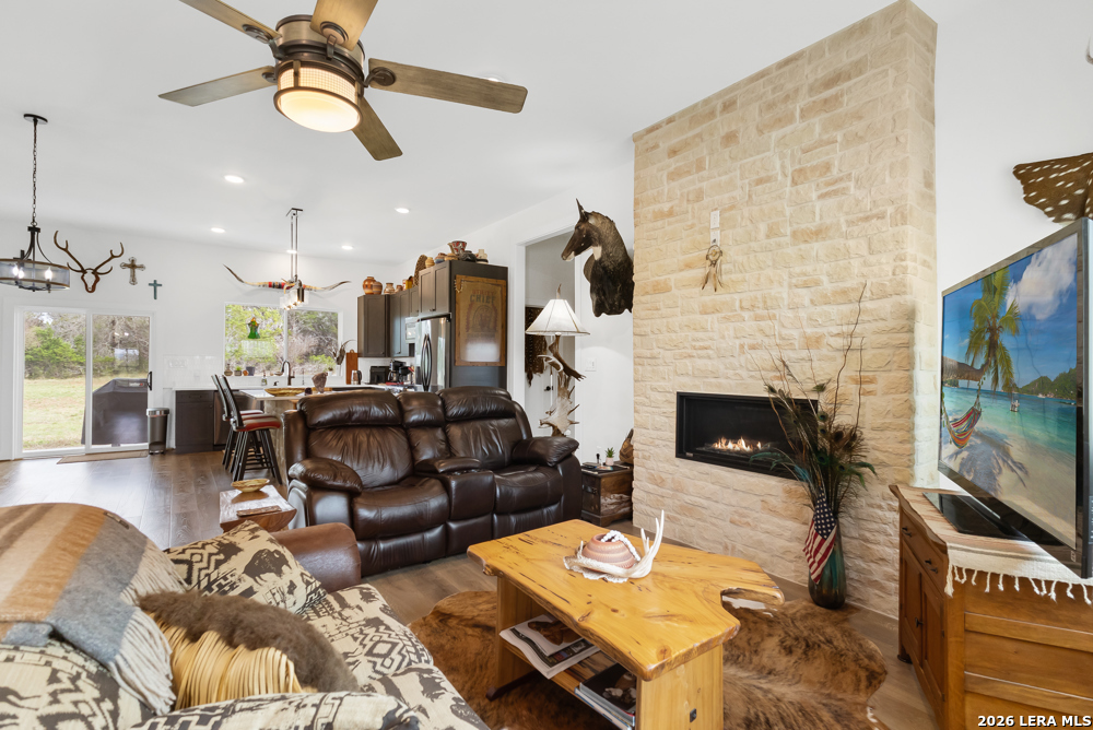 175 Pine Tree Road Medina, TX 78055 - Photo 13 of 34 a living room with furniture and a fireplace