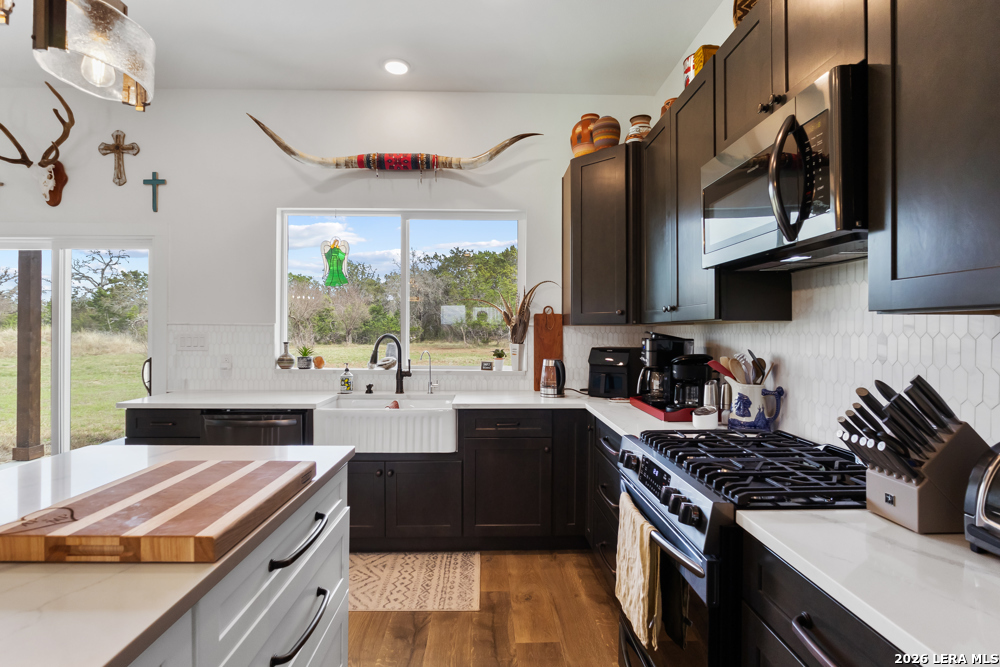 175 Pine Tree Road Medina, TX 78055 - Photo 15 of 34 a kitchen with stainless steel appliances a sink stove and cabinets
