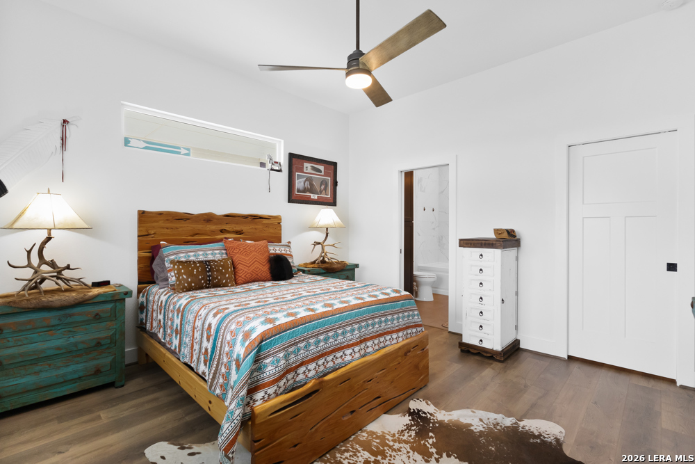 175 Pine Tree Road Medina, TX 78055 - Photo 23 of 34 a bedroom with a bed and a chandelier