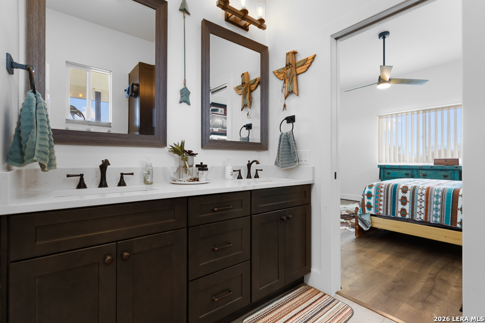 175 Pine Tree Road Medina, TX 78055 - Photo 24 of 34 a en suite bathroom with a double vanity sink and a mirror