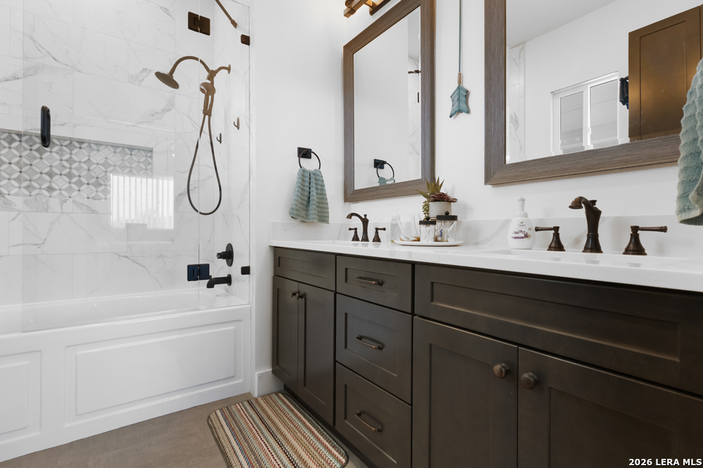 175 Pine Tree Road Medina, TX 78055 - Photo 25 of 34 a bathroom with a double vanity sink a mirror and a bathtub