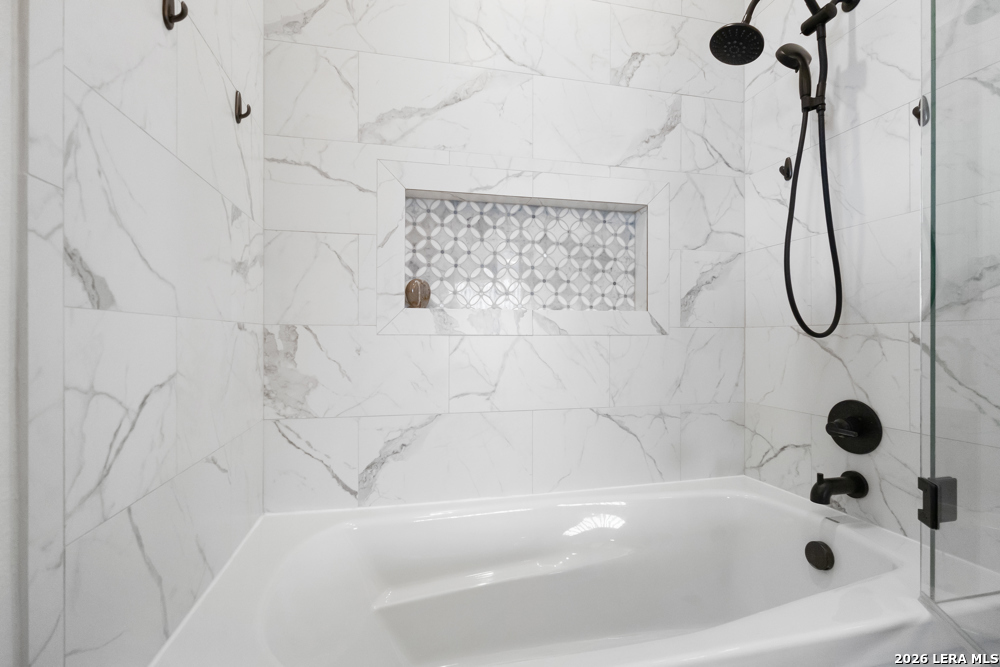 175 Pine Tree Road Medina, TX 78055 - Photo 26 of 34 a bathroom with a bath tub a shower and a window