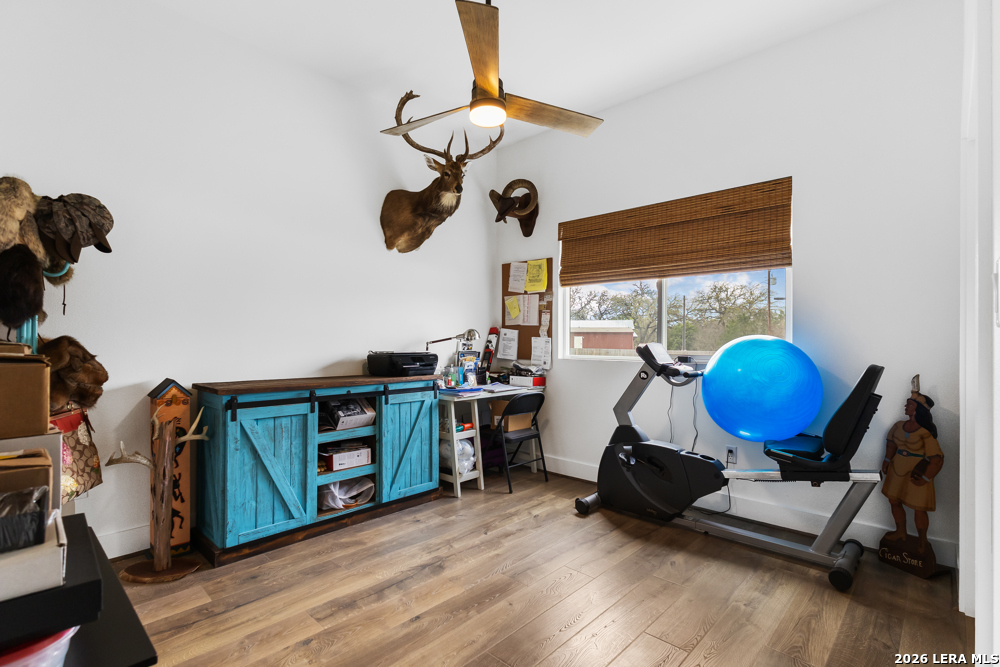 175 Pine Tree Road Medina, TX 78055 - Photo 27 of 34 a living room with furniture a window and wooden floor