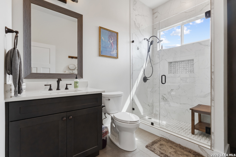 175 Pine Tree Road Medina, TX 78055 - Photo 28 of 34 a bathroom with a sink a toilet and shower