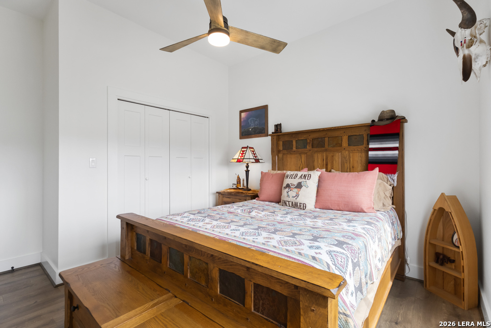 175 Pine Tree Road Medina, TX 78055 - Photo 30 of 34 a bedroom with a bed and a chandelier