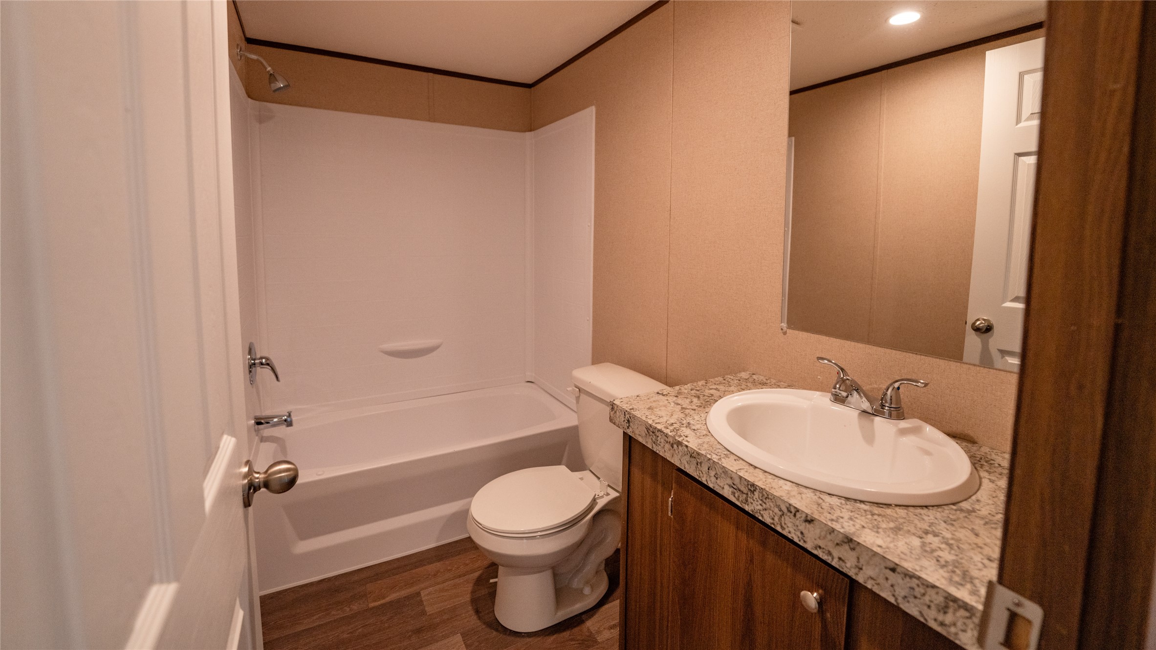 1121 Callihan Road Luling, TX 78648 - Photo 18 of 35 a bathroom with a granite countertop sink toilet and shower