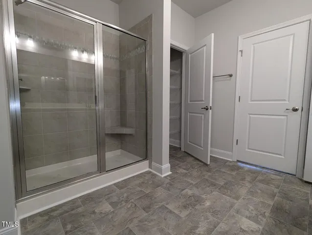 a bathroom with a glass shower door