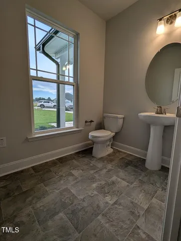 a bathroom with a toilet sink and window