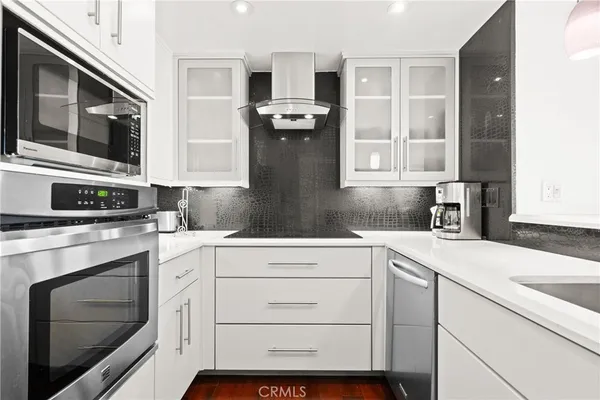 a kitchen with granite countertop cabinets stainless steel appliances and a sink