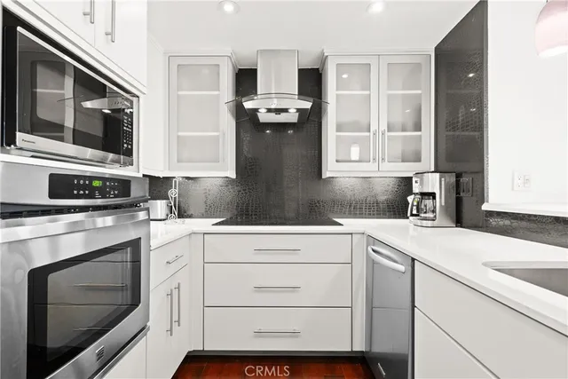 a kitchen with granite countertop cabinets stainless steel appliances and a sink