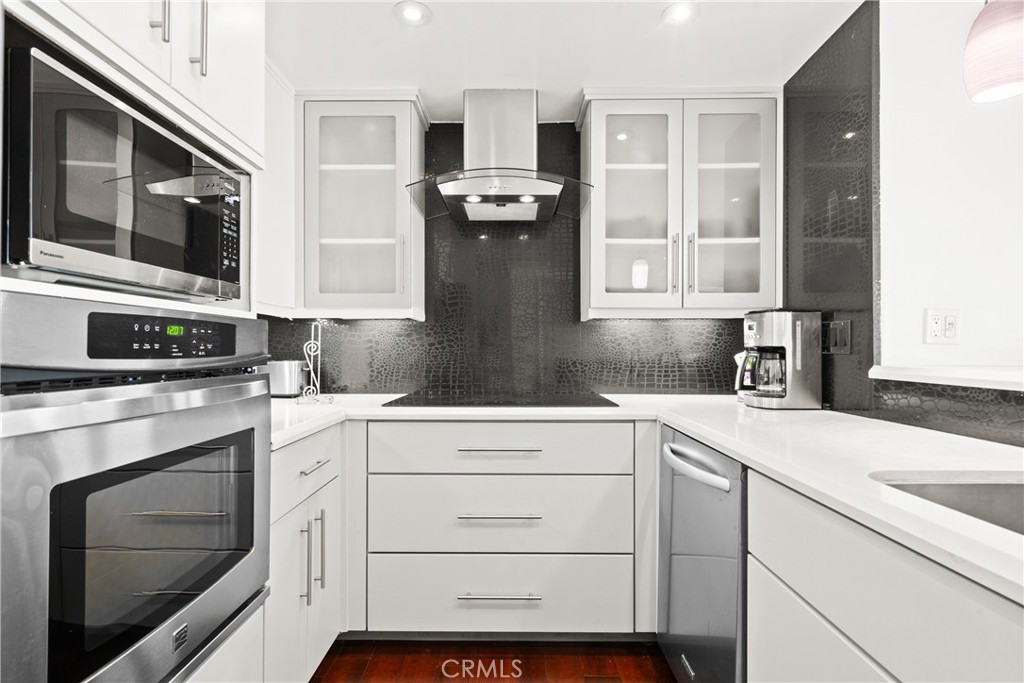700 East Ocean Boulevard, Unit 1104 Long Beach, CA 90802 - Photo 11 of 47 a kitchen with granite countertop cabinets stainless steel appliances and a sink