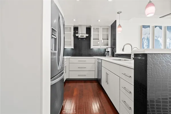 a kitchen with stainless steel appliances a refrigerator sink and cabinets