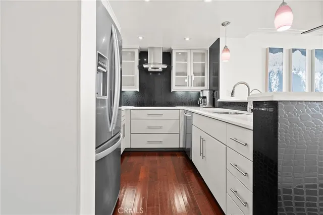 a kitchen with stainless steel appliances a refrigerator sink and cabinets