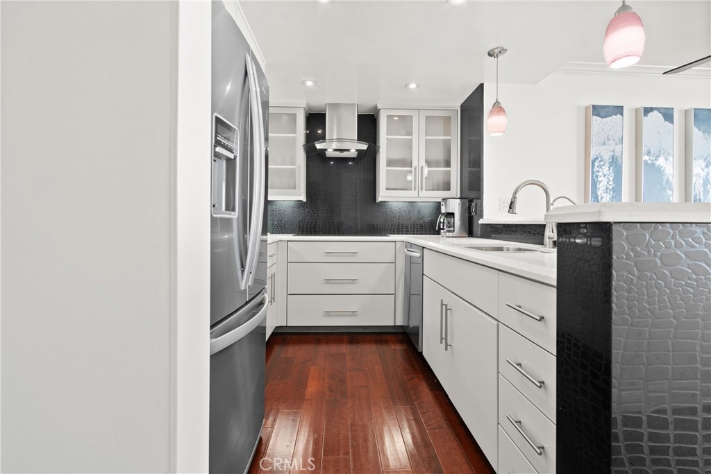 700 East Ocean Boulevard, Unit 1104 Long Beach, CA 90802 - Photo 13 of 47 a kitchen with stainless steel appliances a refrigerator sink and cabinets