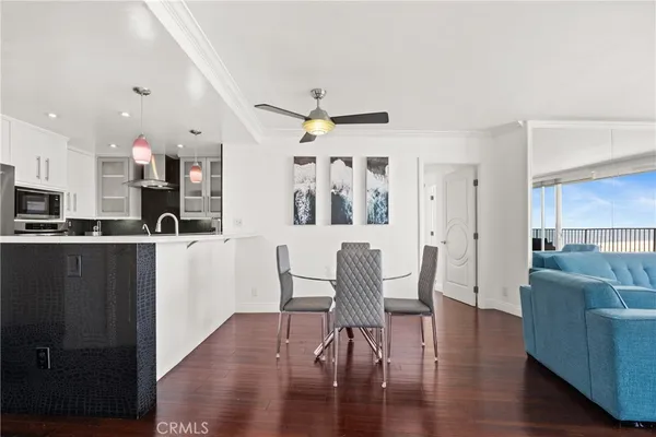 a living room with furniture and kitchen view