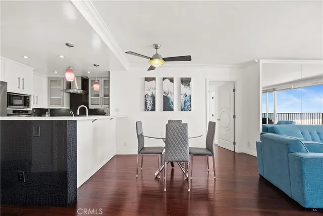 a living room with furniture and kitchen view