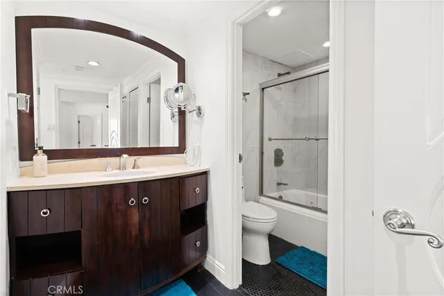 a spacious bathroom with a double vanity sink toilet and shower
