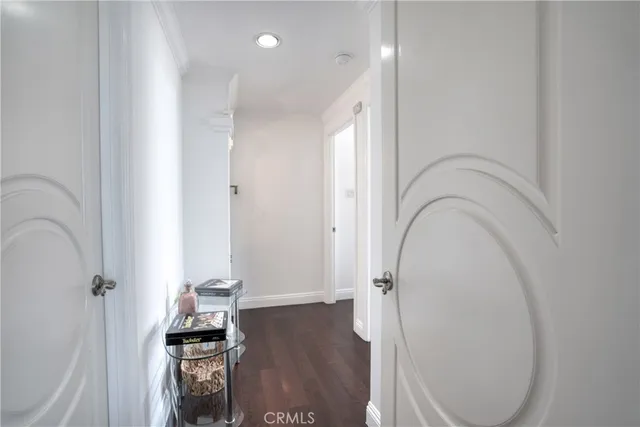 an entryway with wooden floor and a sink