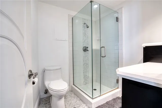a bathroom with a toilet sink and shower