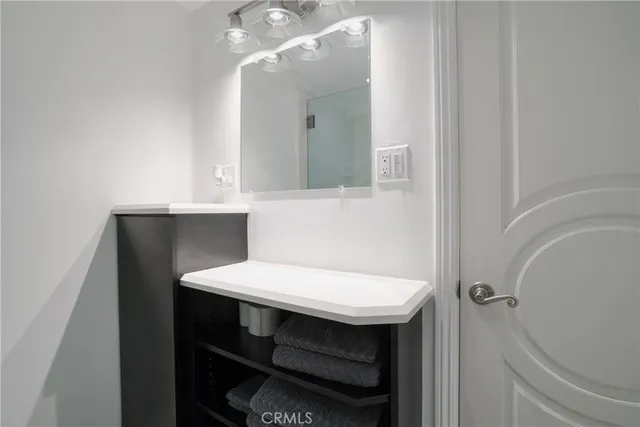 a bathroom with a sink a toilet and mirror