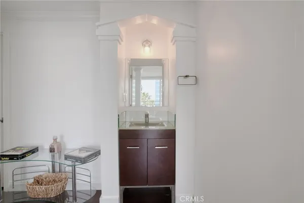 a bathroom with a granite countertop sink a toilet and mirror